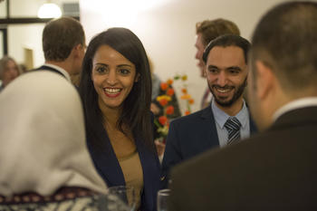 Sawsan Chebli, who represents the state of Berlin in the German federal government and is State Secretary for Civic Engagement and Intercultural Affairs, and Muhammed Al Zeen talking with Raghad Koko (at left, from back) and Mohamed Ali Mohamed