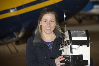 Mirjam den Hoed with the sensor that was built into the research plane.