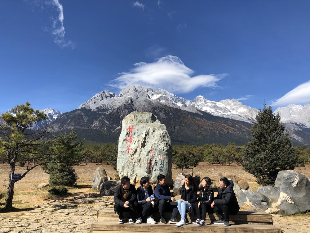 Vivi Feng with a group of friends in front of the Jade Dragon Snow Mountains in Lijiang.
