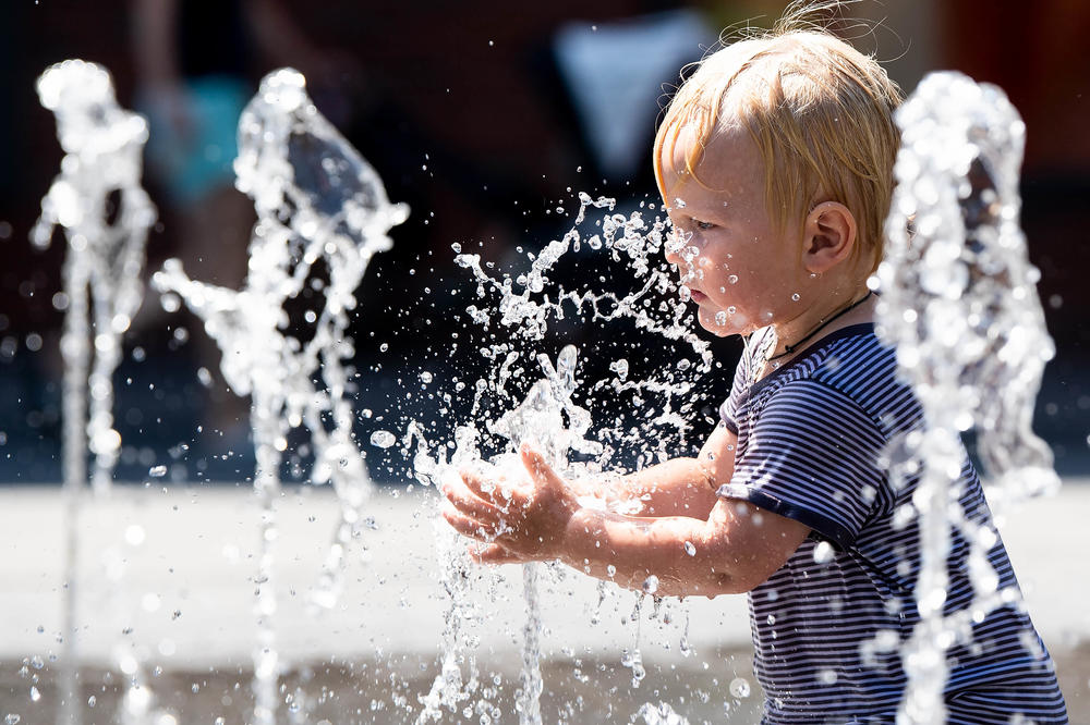 A nice way to beat the heat. A two-year-old splashes in an urban fountain in July 2019 at temperatures near 40 degrees Celsius.