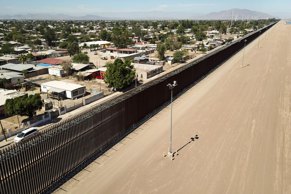 Liberalism is in a bind. Take places where populists beef up existing borders, as Donald Trump has done between Mexico and California. This image shows the border fence watched over by police.