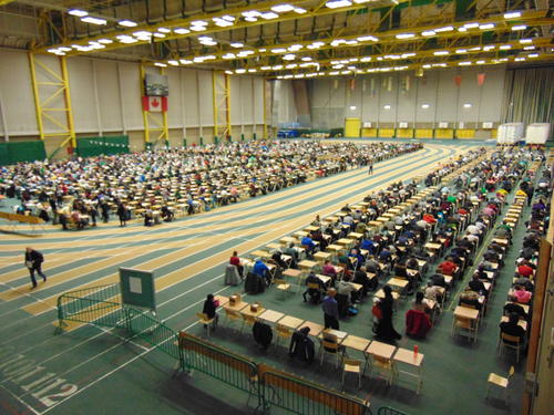 Written tests in the gym: In Canada written tests are taken together, regardless of subject and school year. In this gym there was space for 2880 students in the 36 rows of 80 tables.