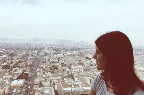 From the Torre Latinoamericana (Latin-American Tower), a skyscraper in downtown Mexico City, Estefanía looks out across the city.