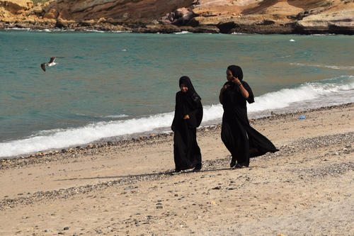 An abaya, a black cloak, is worn by many women in Oman.