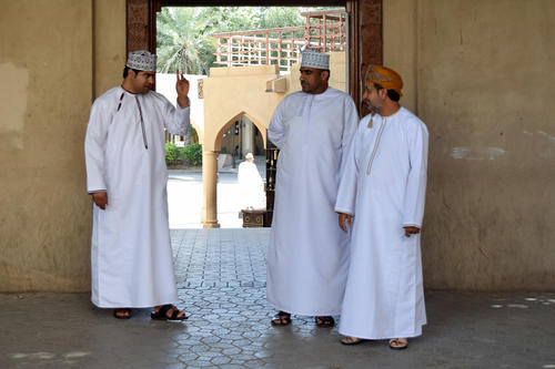Menswear in Oman: The ankle-length tunic is called a 'dishdasha'; the headdress is known as 'kuma' or 'massar.'