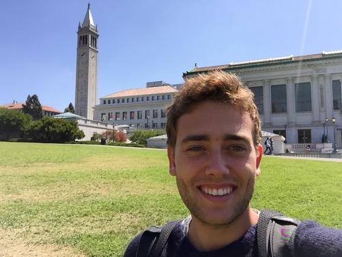 Selfie in front of the Sather Tower, the landmark of the University of California, Berkeley. The university library is at the right.
