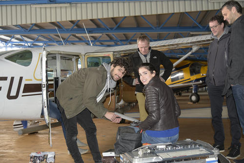 Thomas Ruhtz (second from left) of Freie Universität and Dirk Schüttemeyer (second from right) of the European Space Agency (ESA) work with students to prepare sensors for installation.
