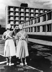 Two nurses admiring the newly completed nurses' quarters on the campus of the new university hospital complex in Steglitz. The nurses' quarters were funded by the Benjamin Franklin Foundation and were dedicated on July 4, 1962.