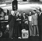 Paul G. Hoffmann, President of the Ford Foundation, handing over the first delivery of the 20,000 books that the American Brotherhood was to collect for Freie Univ. to Freiherr von Kreß, President of Freie Universität, at Tempelhof Airport.