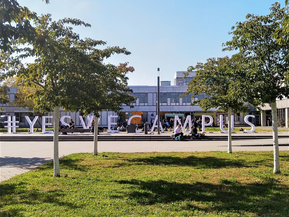 Freie Universität Berlin campus with the #YESWECAMPUS slogan in large freestanding letters. 
