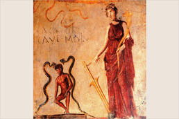 Wandmalerei mit Kraftausdrücken: „Cacator / cave malu“ (dt. „Scheißer, hüte dich vor Ärger“) warnt eine antike Göttin den nackten hockenden Mann an einem Gebäude in Pompeji.